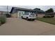 Long concrete driveway leading to a home with a brick and blue exterior, showing ample parking space at 290 W 1St Ave, Broomfield, CO 80020
