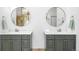 Beautiful bathroom with double sink vanity, marble countertops, and circular mirrors at 1943 Columbine Ct, Golden, CO 80401