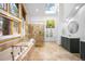 Bright bathroom with a luxurious tub, glass-enclosed shower, dual shower heads and stylish vanity at 1943 Columbine Ct, Golden, CO 80401