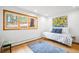Bright bedroom featuring a large window and a daybed with stylish blue patterned bedding and a matching blue rug at 1943 Columbine Ct, Golden, CO 80401