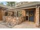 Inviting home exterior with stone accents, a stylish blue front door, and well-maintained landscaping at 1943 Columbine Ct, Golden, CO 80401