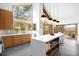 Bright, modern kitchen with island seating, wood cabinets, and large windows with tree views at 1943 Columbine Ct, Golden, CO 80401