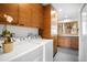 Well-organized laundry room with modern washer and dryer, wood cabinets, and view to the outside at 1943 Columbine Ct, Golden, CO 80401