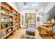 Sunlit area with bookshelves, skylights, hardwood floors, and comfortable lounge chair at 1943 Columbine Ct, Golden, CO 80401