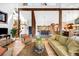 Open-concept living room leading to dining area, featuring wood beams, stairs, and stylish decor at 1943 Columbine Ct, Golden, CO 80401
