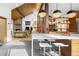 Spacious living area featuring a stone fireplace, modern kitchen, and open-concept design at 1943 Columbine Ct, Golden, CO 80401