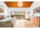 Bright main bedroom featuring a wooden ceiling, hardwood floors, and private balcony with beautiful mountain views at 1943 Columbine Ct, Golden, CO 80401