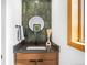 Chic powder room with green tile accent wall, wood vanity, and modern fixtures at 1943 Columbine Ct, Golden, CO 80401