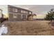 Backyard with a spacious lawn and covered patio, perfect for outdoor living and entertaining at 2776 Badlands Ct, Castle Rock, CO 80109