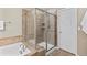 Bathroom with soaking tub and glass enclosed shower with tile surround and built-in shelving at 2776 Badlands Ct, Castle Rock, CO 80109