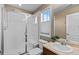 Bathroom with a shower featuring a glass door, a large mirror, and a neutral color palette at 2776 Badlands Ct, Castle Rock, CO 80109