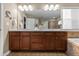 This bathroom boasts a double sink vanity with ample cabinet space, framed mirror, shower, and soaking tub at 2776 Badlands Ct, Castle Rock, CO 80109