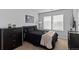 This bedroom features a window, closet, black furniture, neutral carpet and walls at 2776 Badlands Ct, Castle Rock, CO 80109