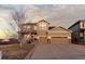 Inviting two-story home with a three-car garage and a covered porch, perfect for suburban living at 2776 Badlands Ct, Castle Rock, CO 80109