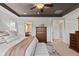 The main bedroom boasts a white cushioned bench, and a wooden dresser, with easy access to a bathroom at 2776 Badlands Ct, Castle Rock, CO 80109