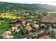 Beautiful aerial view of the home nestled in a neighborhood surrounded by red rock formations at 10751 Fairway Vistas Ct, Littleton, CO 80125