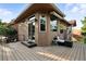 Inviting outdoor deck area featuring outdoor seating, awning and mature landscaping for the ultimate in outdoor living and entertaining at 10751 Fairway Vistas Ct, Littleton, CO 80125