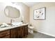 Neutral powder room features a granite countertop, vessel sink, stylish fixtures and ample lighting at 10751 Fairway Vistas Ct, Littleton, CO 80125
