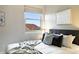Cozy bedroom features mountain view, neutral decor, and comfortable bedding with stylish pillows and throw blanket at 10751 Fairway Vistas Ct, Littleton, CO 80125