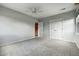 Spacious bedroom featuring neutral carpet, walk-in closet, ceiling fan, and bright atmosphere at 10751 Fairway Vistas Ct, Littleton, CO 80125