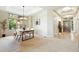 Bright dining room showcases a modern light fixture, large windows, and a seamless transition to the entry at 10751 Fairway Vistas Ct, Littleton, CO 80125