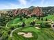 Scenic aerial view of golf course with red rocks at 10751 Fairway Vistas Ct, Littleton, CO 80125