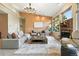 Bright living room features vaulted ceilings, gas fireplace, large windows, stylish furniture, and natural light at 10751 Fairway Vistas Ct, Littleton, CO 80125
