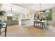 Open concept living room connects to dining area, featuring a fireplace, hardwood floors, and natural light at 10751 Fairway Vistas Ct, Littleton, CO 80125