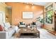 Spacious living room with a cozy seating arrangement and a large window overlooking lush greenery at 10751 Fairway Vistas Ct, Littleton, CO 80125