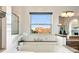 Inviting soaking tub with a view window, stylish fixtures, and granite surround at 10751 Fairway Vistas Ct, Littleton, CO 80125