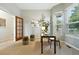 Stylish home office with wood door, plant, desk, chair, and decor offers a functional and inviting workspace at 10751 Fairway Vistas Ct, Littleton, CO 80125