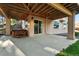 Outdoor patio with hot tub, sliding door to house, and backyard access at 10751 Fairway Vistas Ct, Littleton, CO 80125