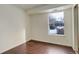 Well-lit bedroom featuring wood-look flooring and a window view at 2575 S Syracuse Way # 108, Denver, CO 80231