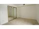 Condo bedroom with mirrored closet doors and carpet at 2575 S Syracuse Way # 108, Denver, CO 80231