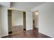 Bedroom with mirrored closet doors and wood-look flooring at 2575 S Syracuse Way # 108, Denver, CO 80231