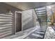 Condo building entryway with a private exterior door and stairs at 2575 S Syracuse Way # 108, Denver, CO 80231
