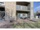 Private patio with seating area, adjacent to a stone wall at 2575 S Syracuse Way # 108, Denver, CO 80231