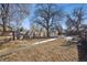 Large backyard with wooden fence and mature trees at 4326 Batavia Pl, Denver, CO 80220