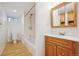 Bathroom with wood-look floor, tub/shower, and wood vanity at 4326 Batavia Pl, Denver, CO 80220