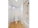 Bathroom with wood-look floor and tub/shower at 4326 Batavia Pl, Denver, CO 80220