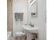 Bathroom with a pedestal sink, tiled walls, and modern fixtures at 4326 Batavia Pl, Denver, CO 80220