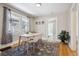 Bright dining room with hardwood floors, a modern table, and large windows at 4326 Batavia Pl, Denver, CO 80220