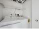 Clean laundry area with white washer and dryer units and ample shelving at 4326 Batavia Pl, Denver, CO 80220