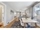 Open-concept living room and dining area featuring hardwood floors, natural light, and stylish decor at 4326 Batavia Pl, Denver, CO 80220