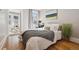 Comfortable main bedroom featuring hardwood floors, a cozy bed, and natural light at 4326 Batavia Pl, Denver, CO 80220