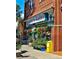 Charming Spinelli's Market facade featuring colorful floral displays and a classic brick building at 4326 Batavia Pl, Denver, CO 80220