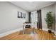 Bright office with hardwood floors, a modern desk, and a large window at 4326 Batavia Pl, Denver, CO 80220
