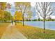 Scenic park view featuring a paved path alongside a calm lake surrounded by vibrant autumn foliage at 4326 Batavia Pl, Denver, CO 80220