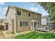 Back exterior elevation features deck, walk-out basement, and mature trees at 1440 E 128Th Ct, Thornton, CO 80241