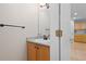 A half-bath with a sink and vanity is conveniently located near the entry, and leads to the kitchen at 1440 E 128Th Ct, Thornton, CO 80241